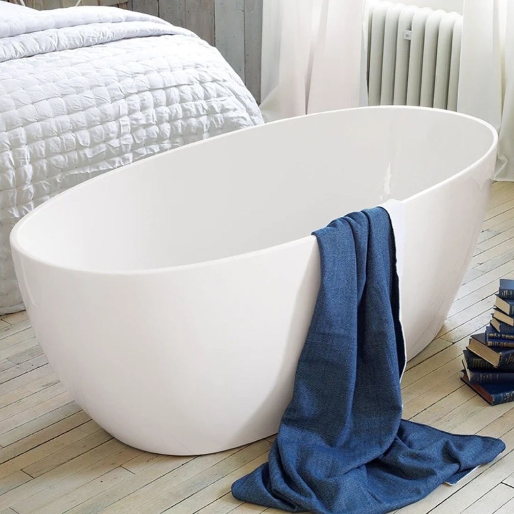 product lifestyle image of waters infinity stream 1700mm double ended freestanding bath with blue towel hanging over edge view from side